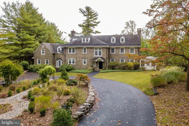 a front view of a house with yard and green space