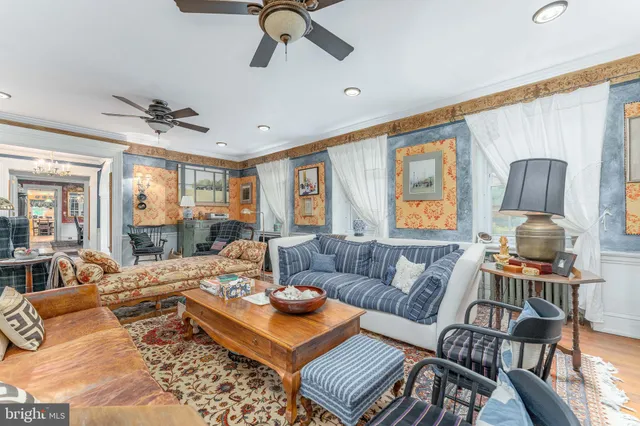 a living room with furniture a rug and a fireplace