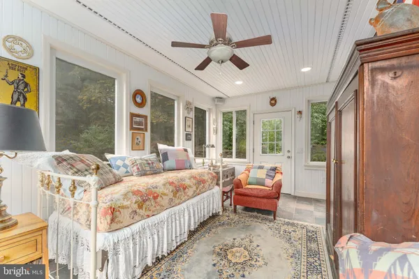 a kitchen with stainless steel appliances kitchen island granite countertop a table chairs in it and wooden floors