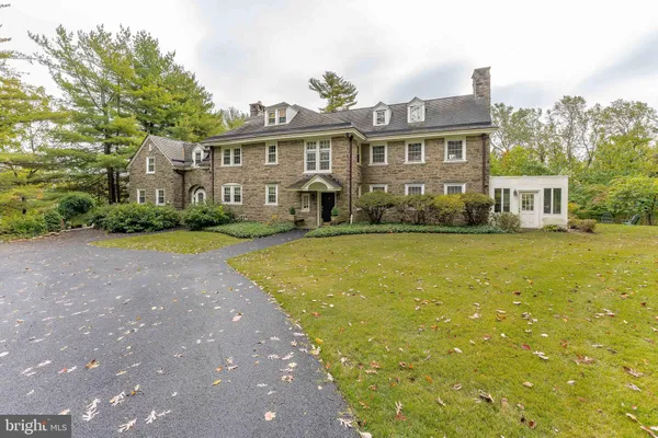 a front view of a house with yard and green space