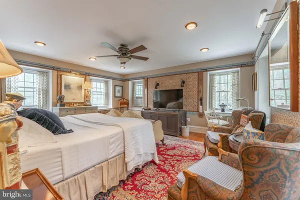 a bedroom with a large bed and a window