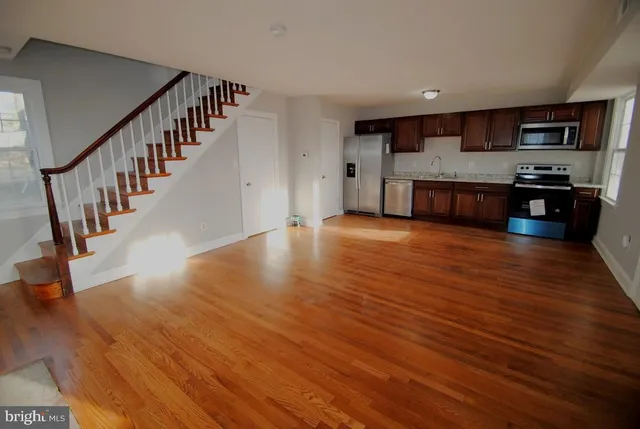 a view of kitchen with microwave and cabinets