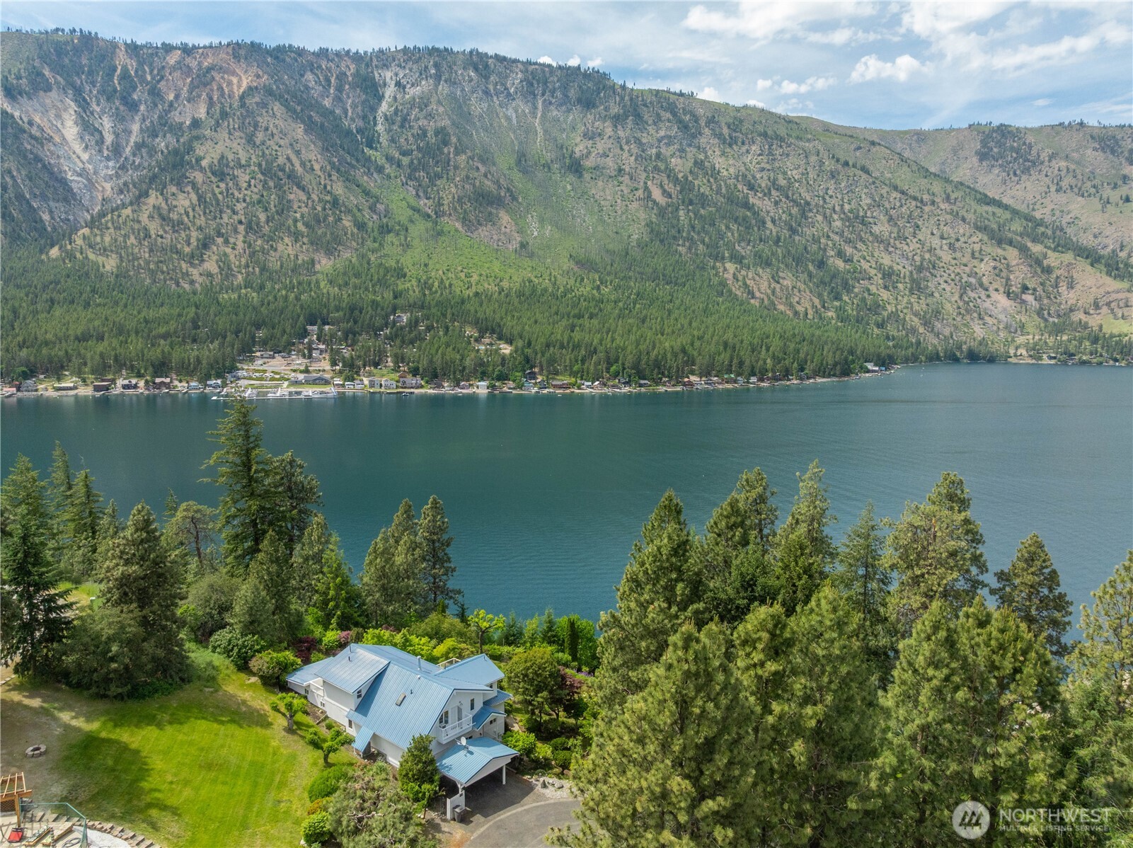 141 Sunset Place Manson, WA 98831 - Photo 3 of 38 an aerial view of a houses with a lake