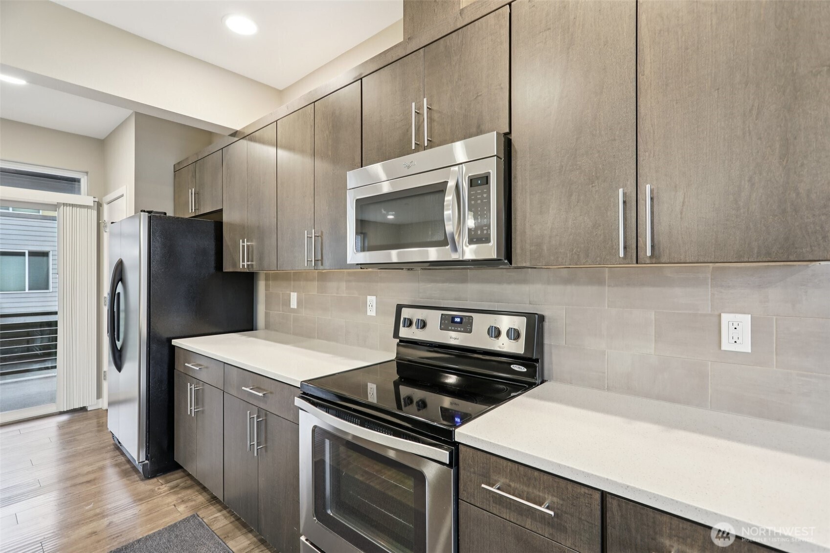 13724 Ash Way, Unit F3 Everett, WA 98204 - Photo 11 of 28 a kitchen with stainless steel appliances a stove a sink and a refrigerator