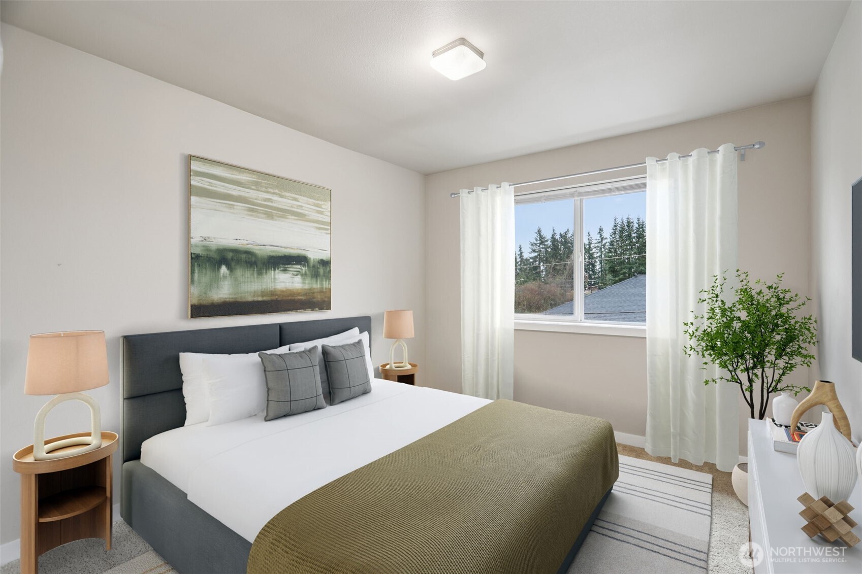 13724 Ash Way, Unit F3 Everett, WA 98204 - Photo 16 of 28 a bedroom with a large bed and a potted plant