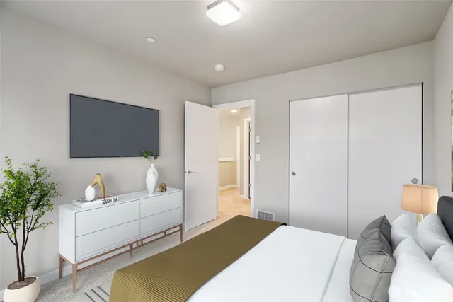 a bedroom with a bed and a flat screen tv