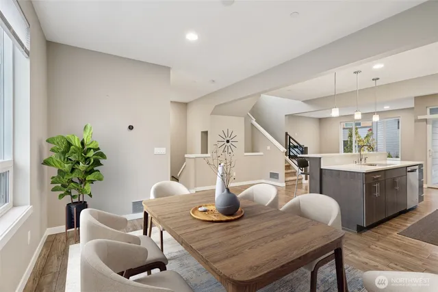a dining room with furniture and wooden floor