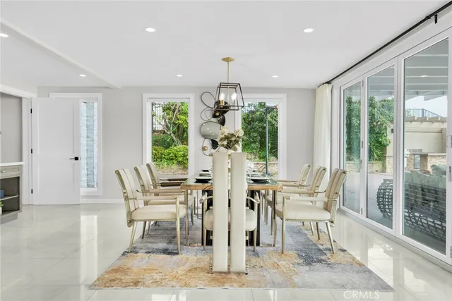 a dining room with furniture a floor to ceiling window and wooden floor