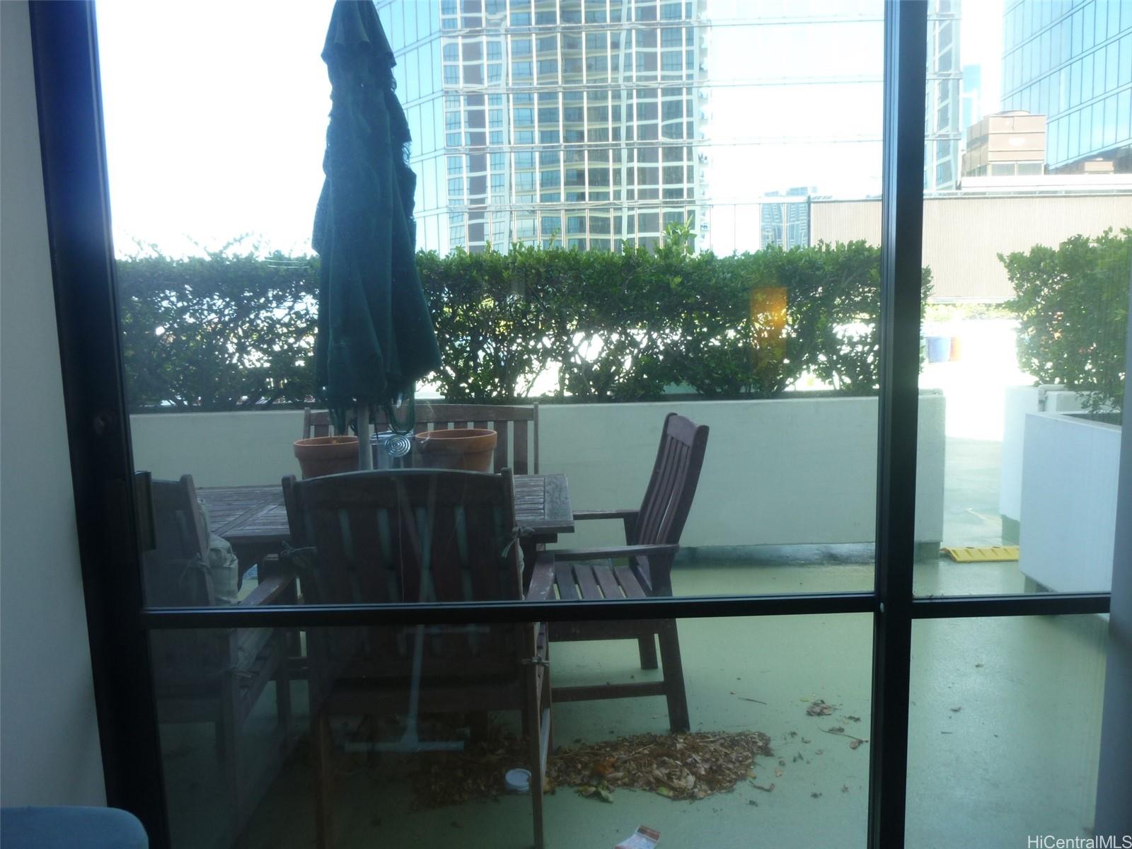 700 Richards Street, Unit 703 Honolulu, HI 96813 - Photo 6 of 12 a view of a balcony with chairs and a table
