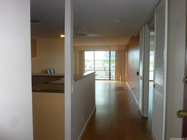 a kitchen with a refrigerator a stove a washer dryer and white cabinets