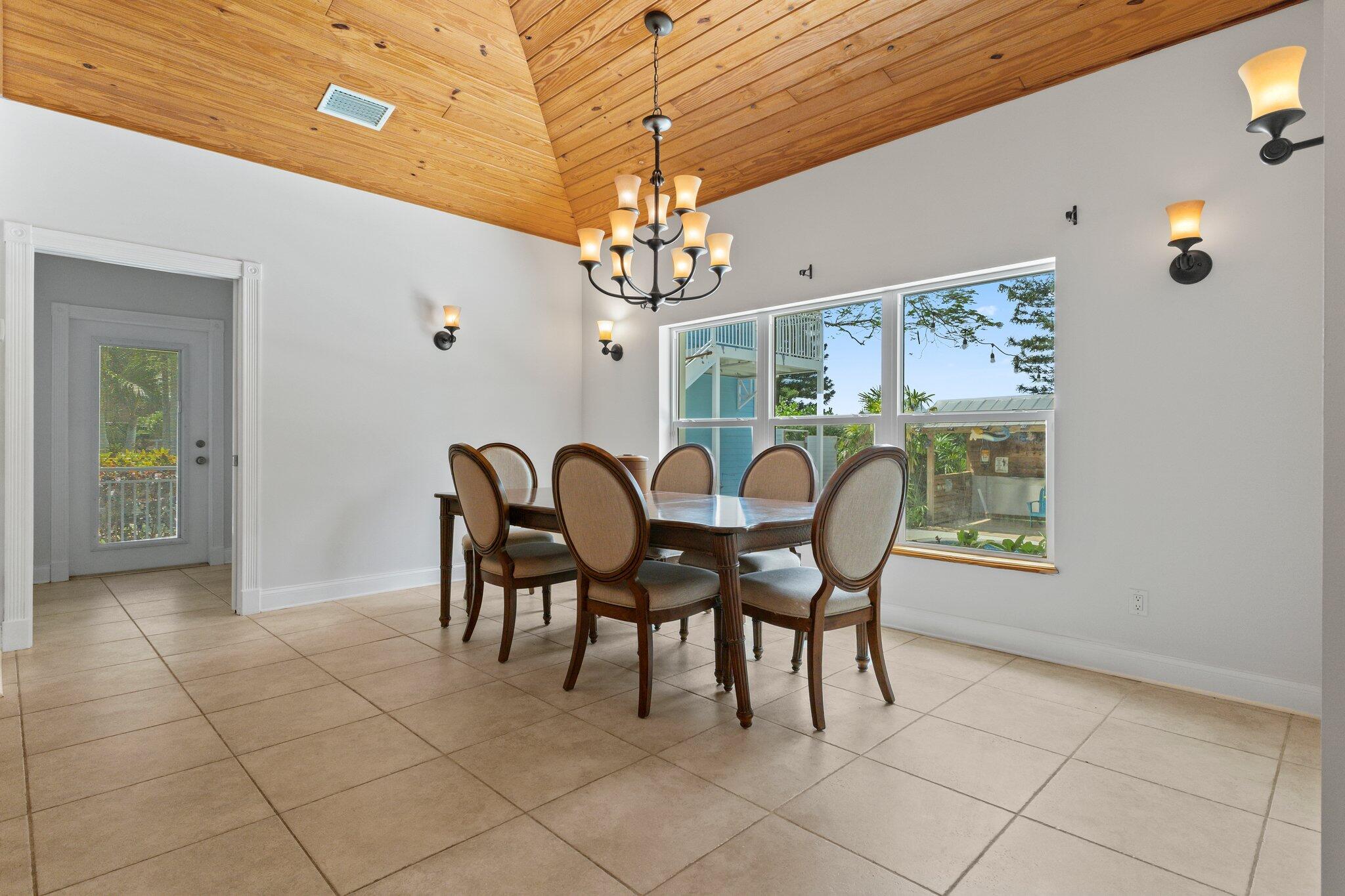 1293 Southwest Heather Terrace Stuart, FL 34997 - Photo 19 of 80 a view of a dining room with furniture and chandelier