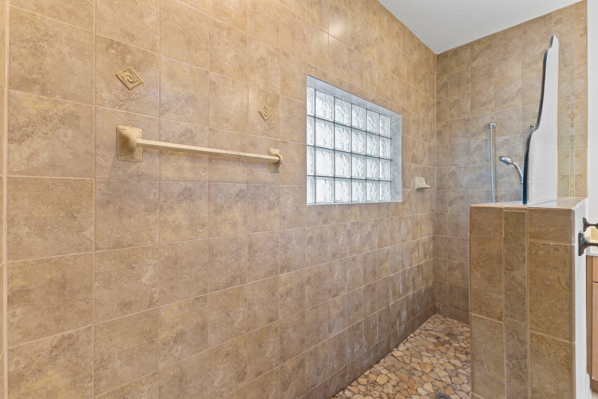 1293 Southwest Heather Terrace Stuart, FL 34997 - Photo 29 of 80 a bathroom with a shower