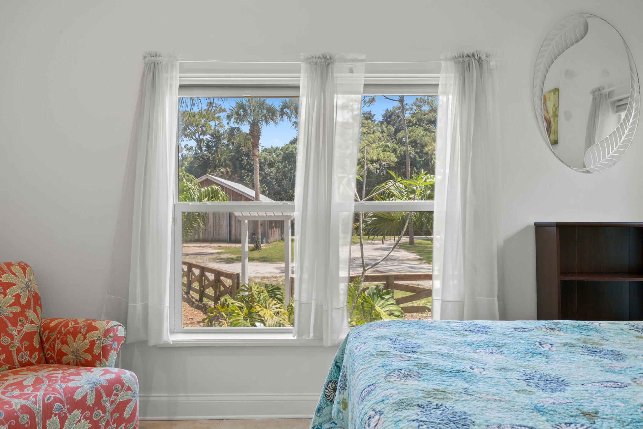 1293 Southwest Heather Terrace Stuart, FL 34997 - Photo 34 of 80 a view of a bedroom with wooden floor and a window