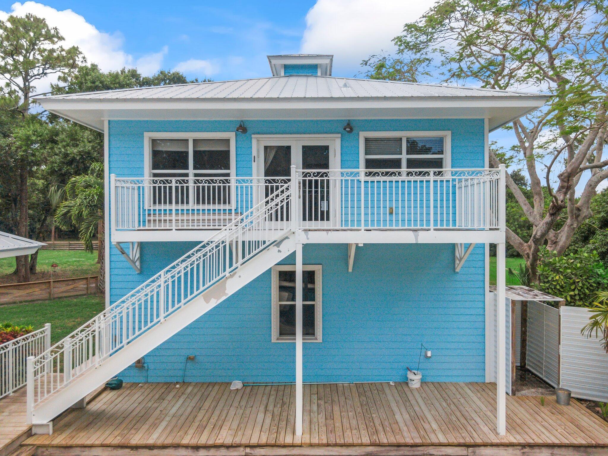 1293 Southwest Heather Terrace Stuart, FL 34997 - Photo 40 of 80 a view of a house with a deck