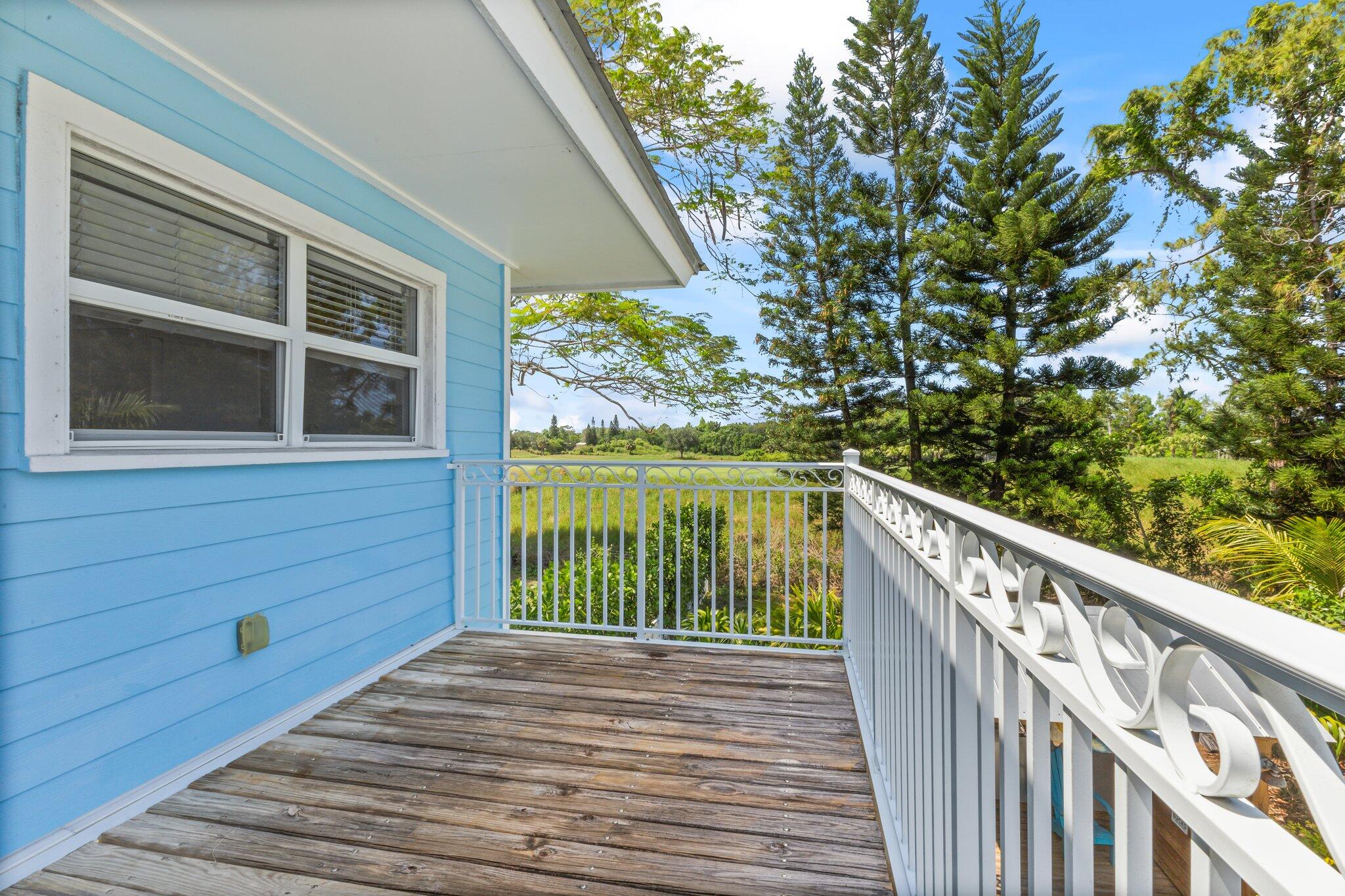 1293 Southwest Heather Terrace Stuart, FL 34997 - Photo 41 of 80 a view of a balcony with wooden floor and fence