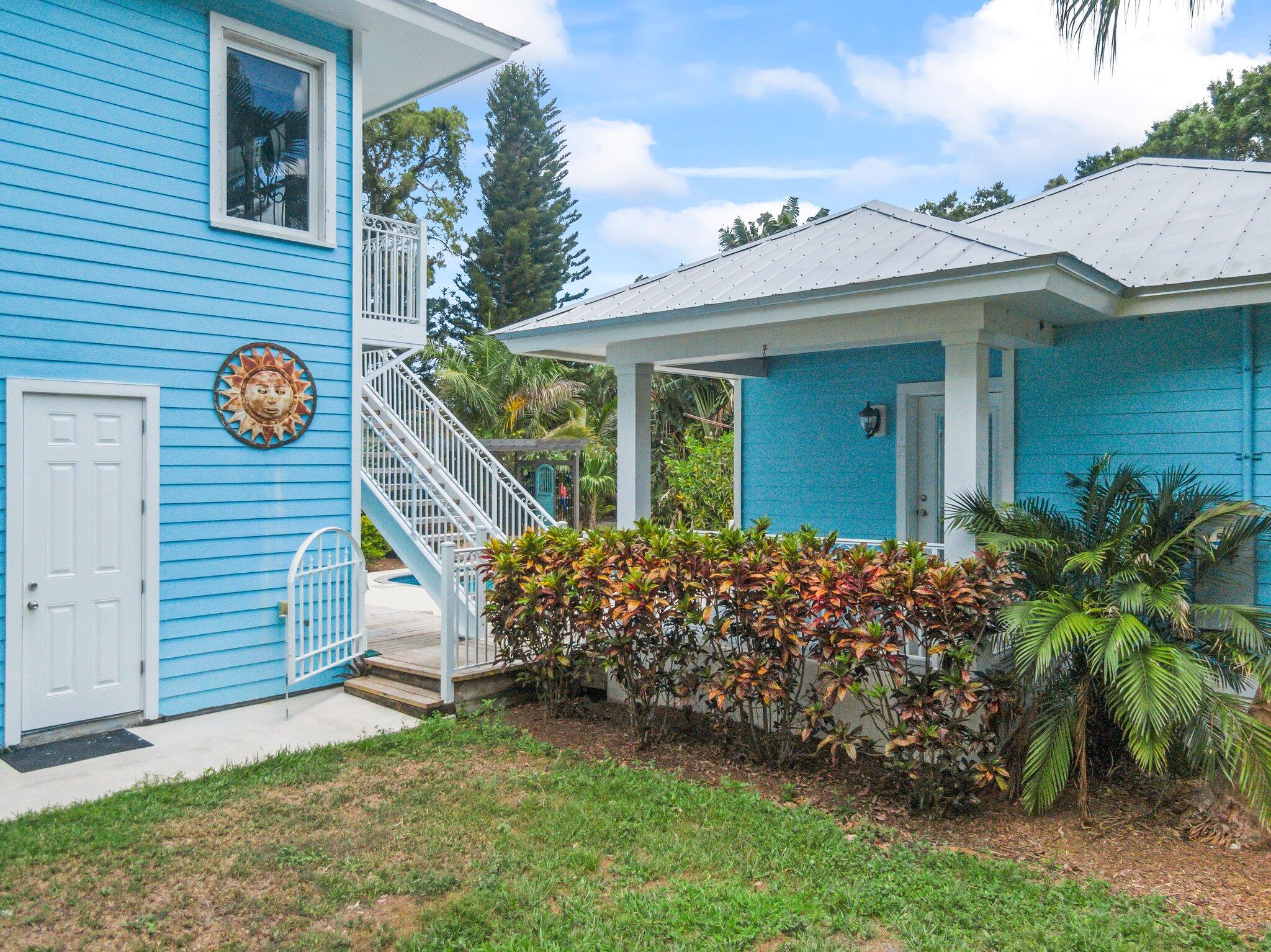 1293 Southwest Heather Terrace Stuart, FL 34997 - Photo 58 of 80 a view of a house with a small yard and a large tree