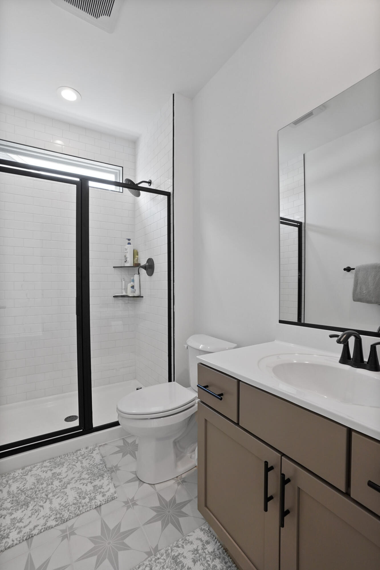 8772 Potomac Way Lowell, IN 46356 - Photo 13 of 30 a bathroom with a sink a toilet a shower and a mirror