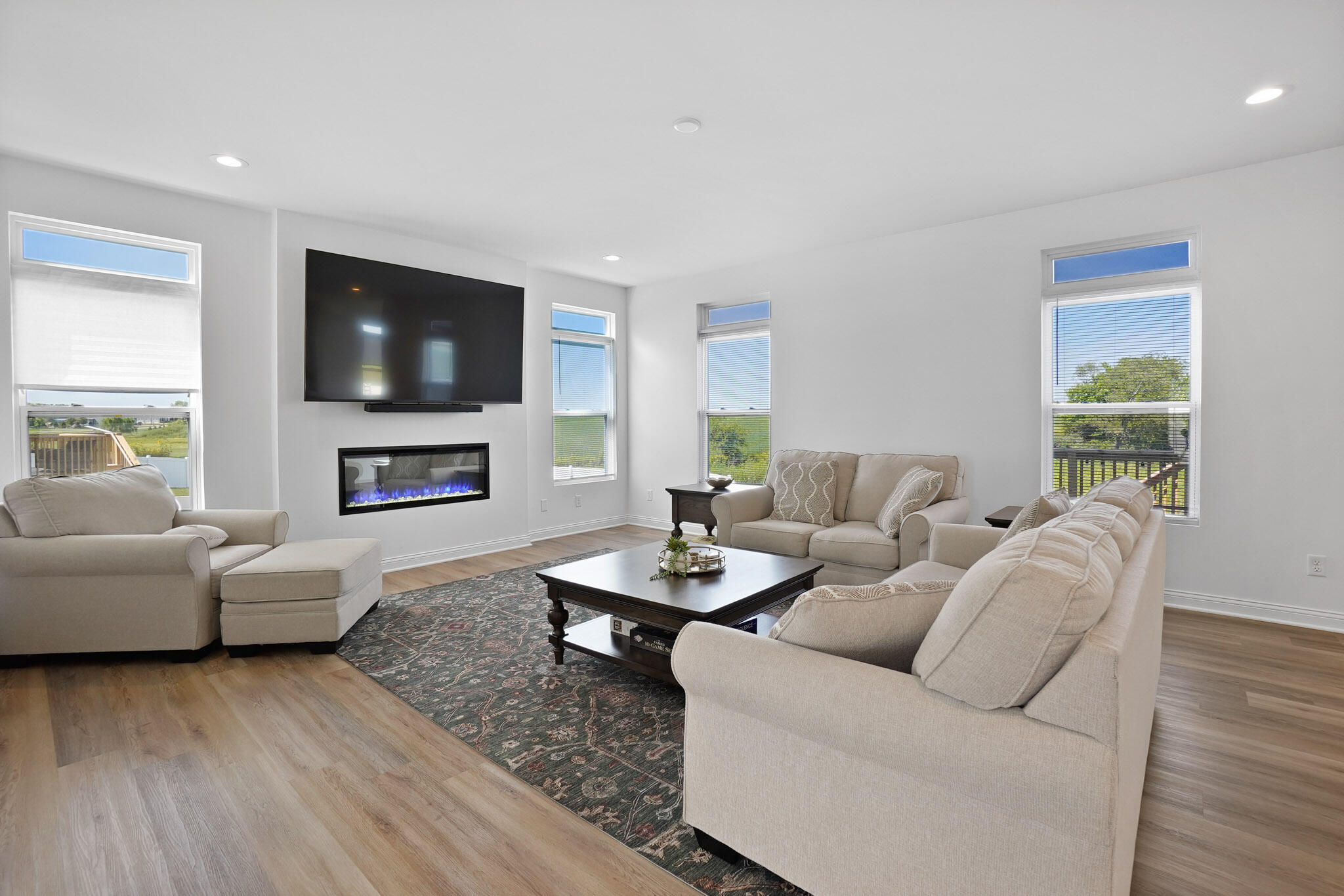 8772 Potomac Way Lowell, IN 46356 - Photo 5 of 30 a living room with furniture a fireplace and a flat screen tv