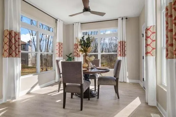 a dining room with furniture and window