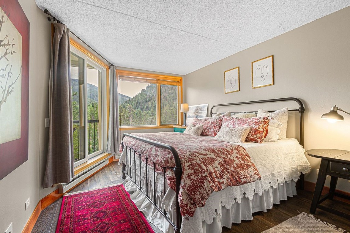 21650 Highway 6, Unit 2110 Keystone, CO 80435 - Photo 14 of 26 a bedroom with a bed next to a large window