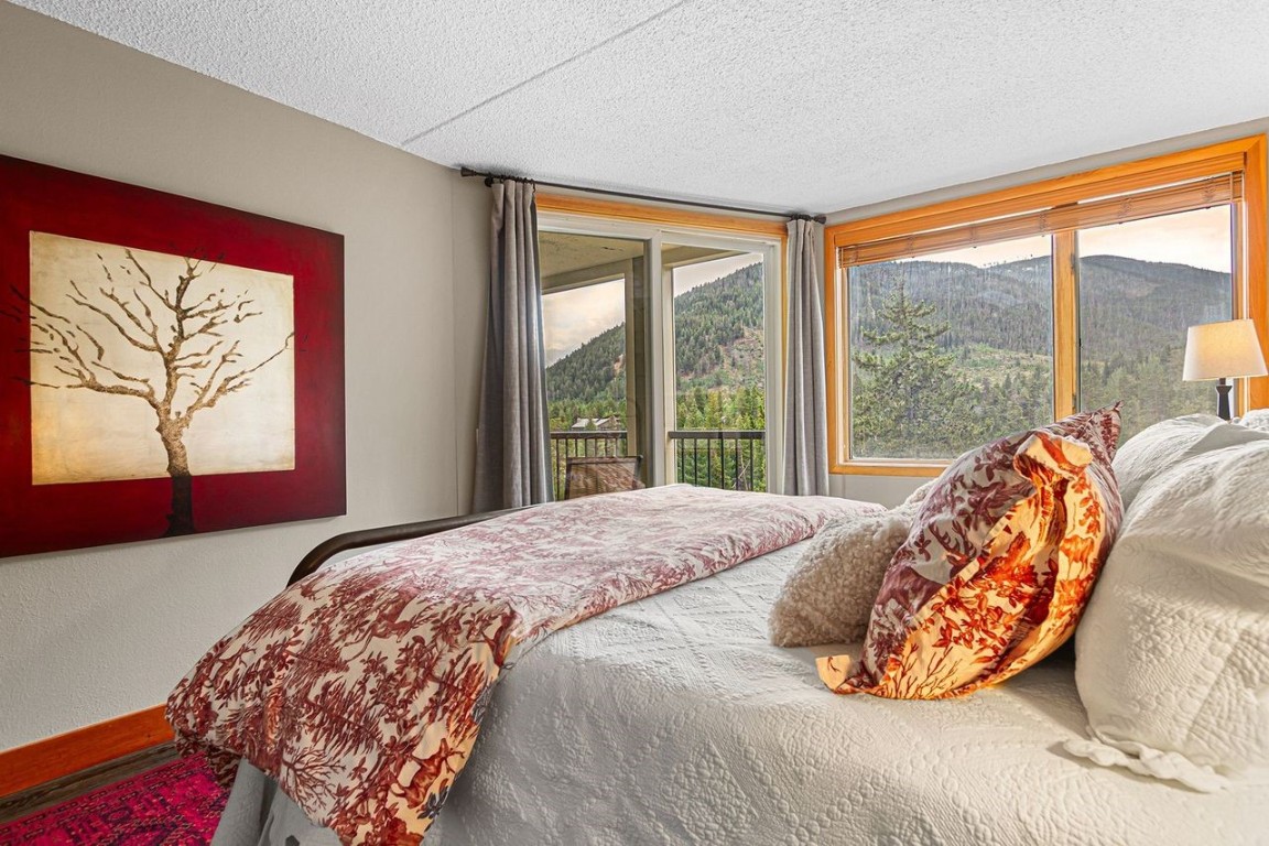 21650 Highway 6, Unit 2110 Keystone, CO 80435 - Photo 15 of 26 a bed sitting in a bedroom next to a window