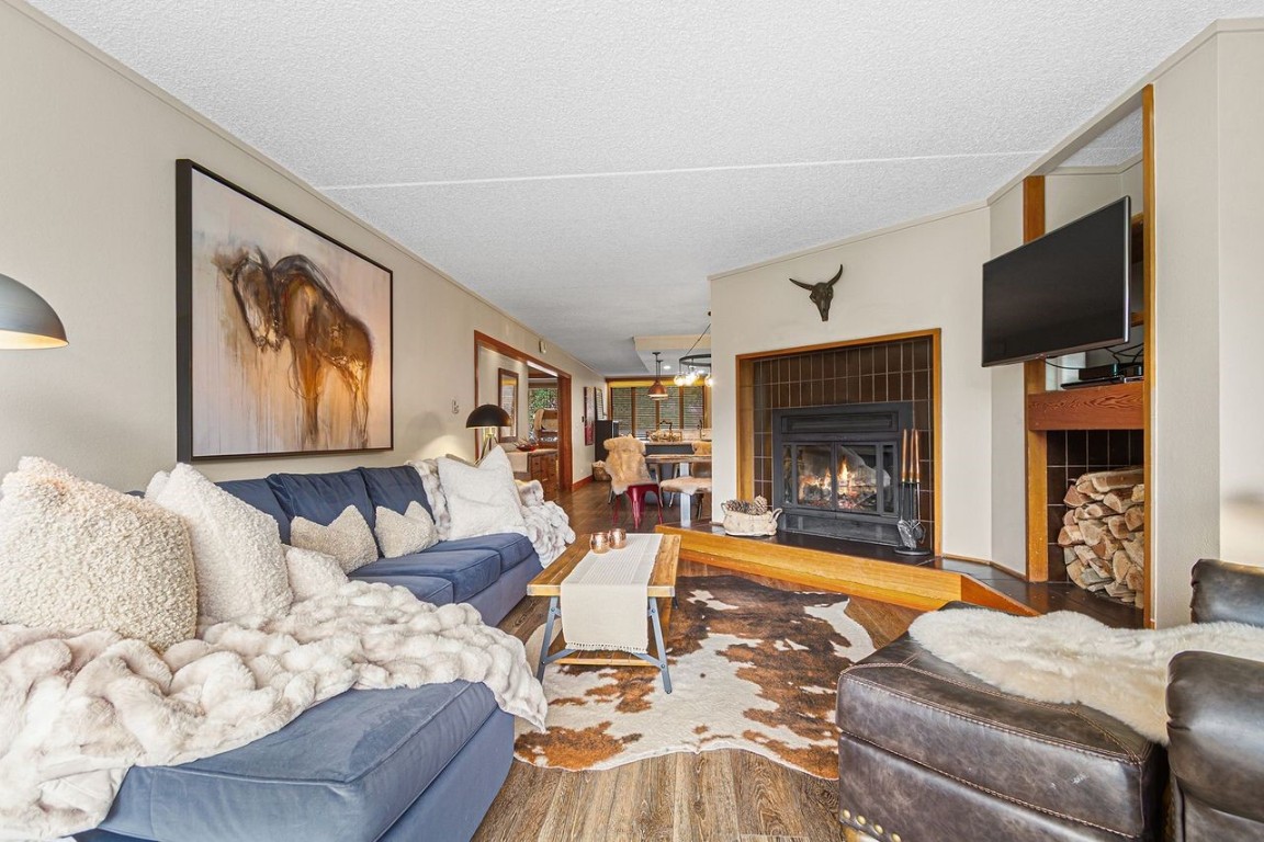 21650 Highway 6, Unit 2110 Keystone, CO 80435 - Photo 4 of 26 a living room with furniture a flat screen tv and a fireplace