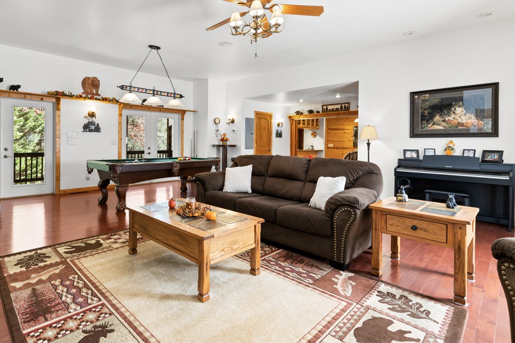 358 Misty River Circle Murphy, NC 28906 - Photo 13 of 62 a living room with furniture a chandelier and a flat screen tv