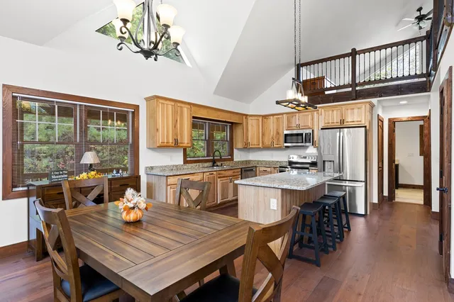 a kitchen with stainless steel appliances granite countertop a sink stove microwave and refrigerator