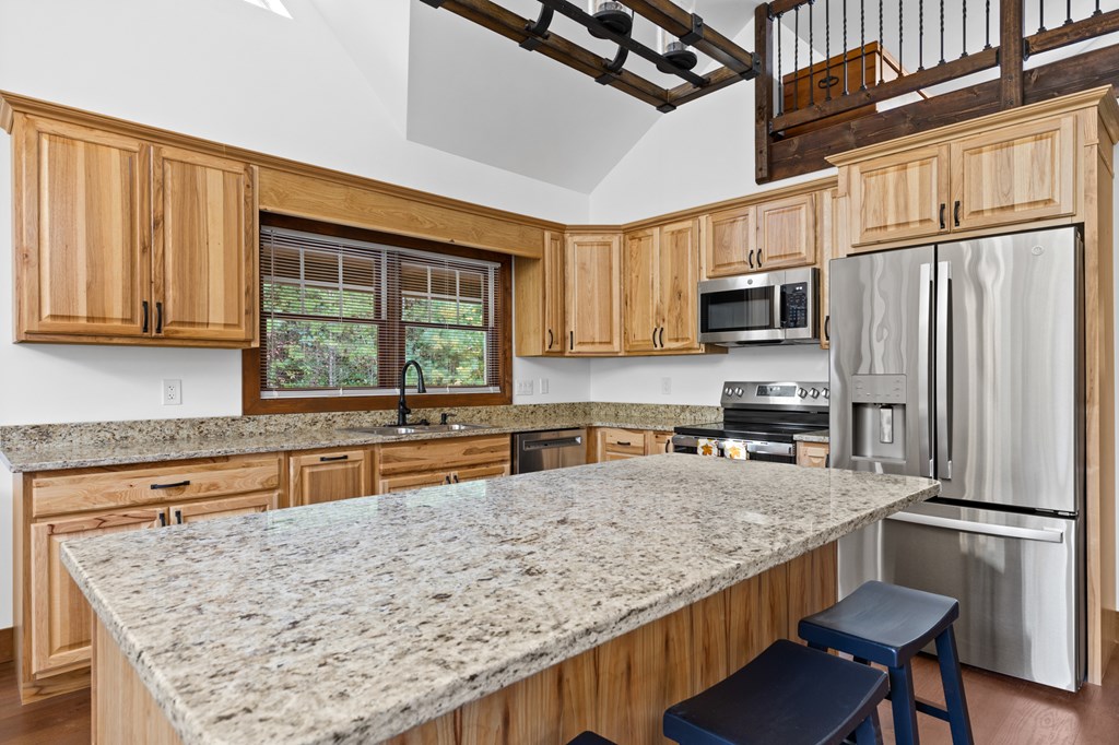 358 Misty River Circle Murphy, NC 28906 - Photo 61 of 62 a kitchen with stainless steel appliances granite countertop a sink stove microwave and refrigerator