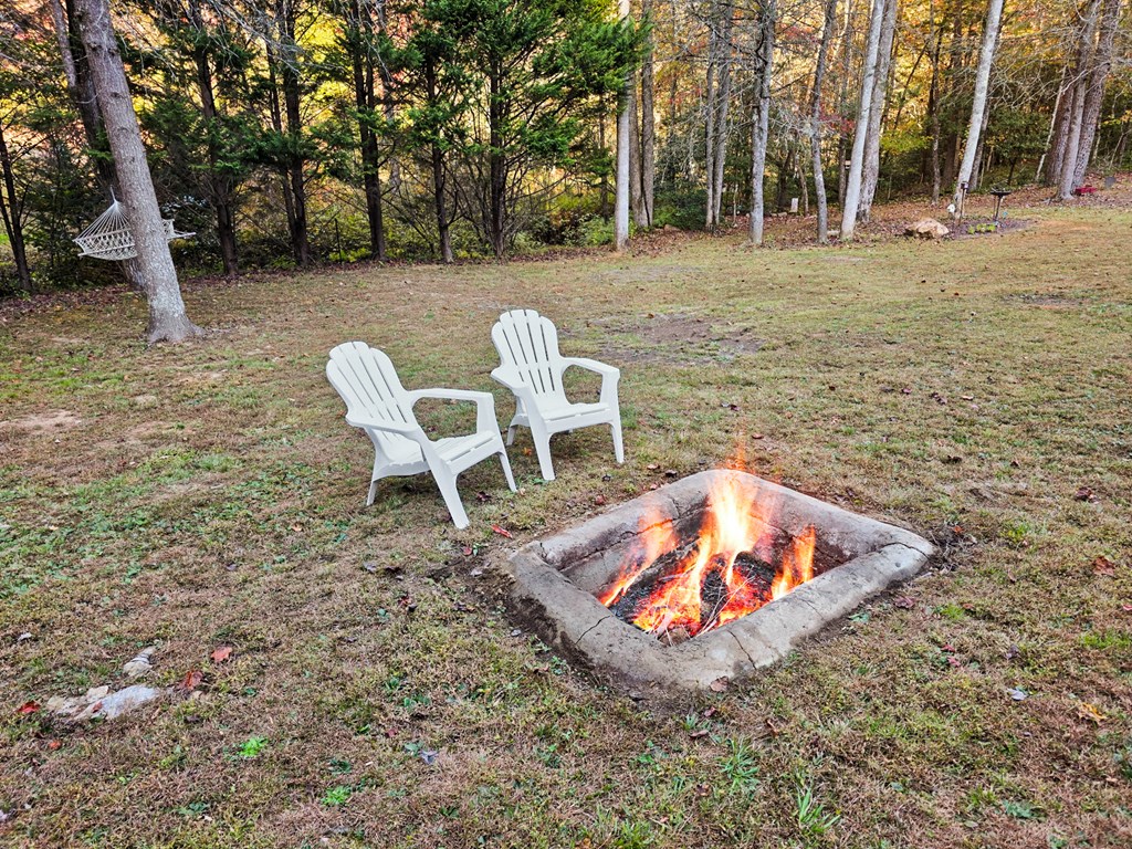 358 Misty River Circle Murphy, NC 28906 - Photo 9 of 62 a table and chairs sitting in the middle of a yard