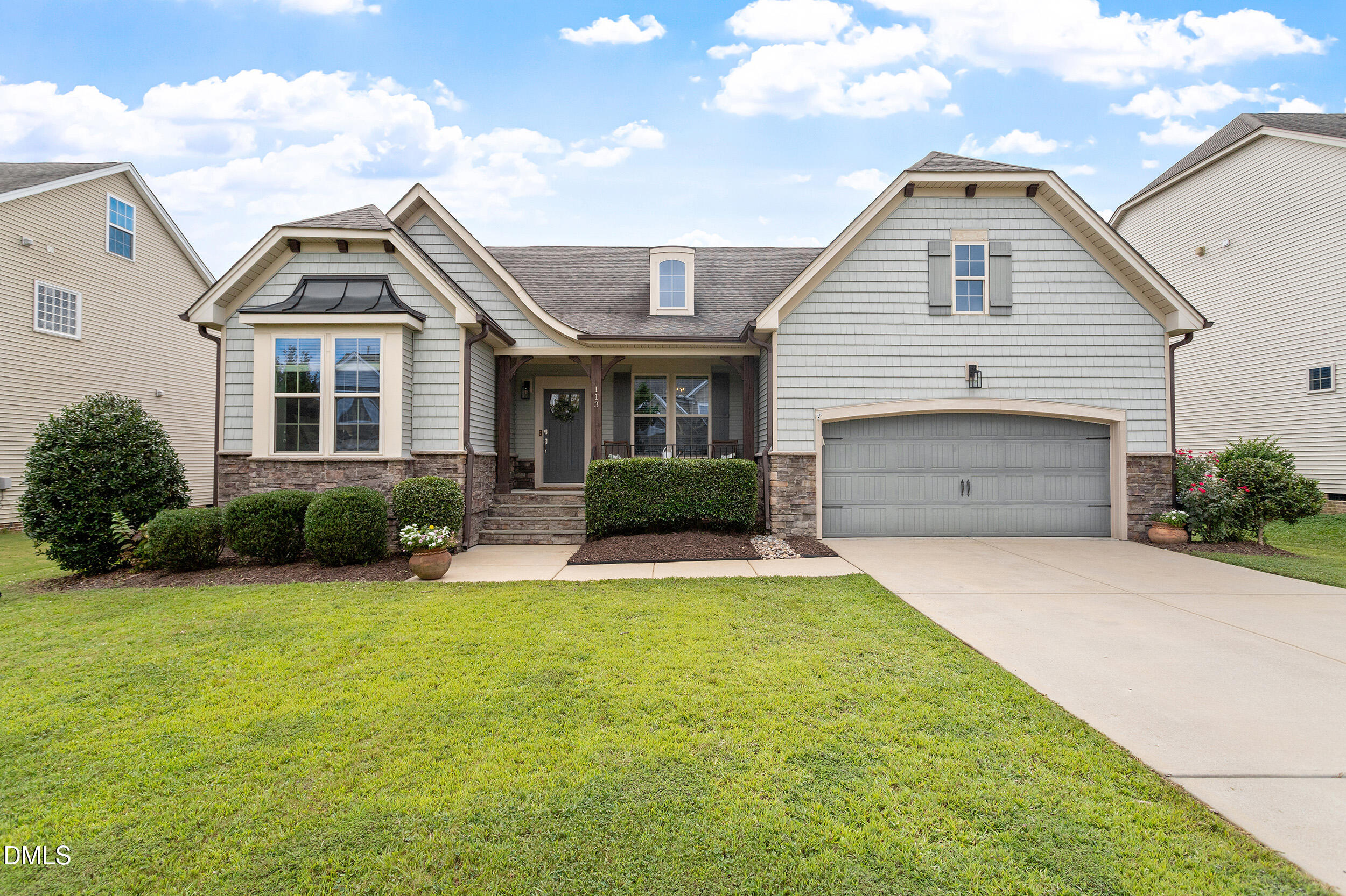 a front view of a house with a yard and garage
