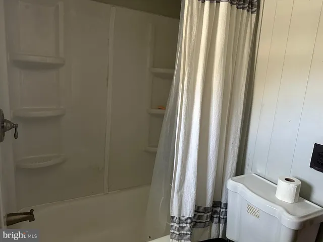 a bathroom with a bathtub and shower