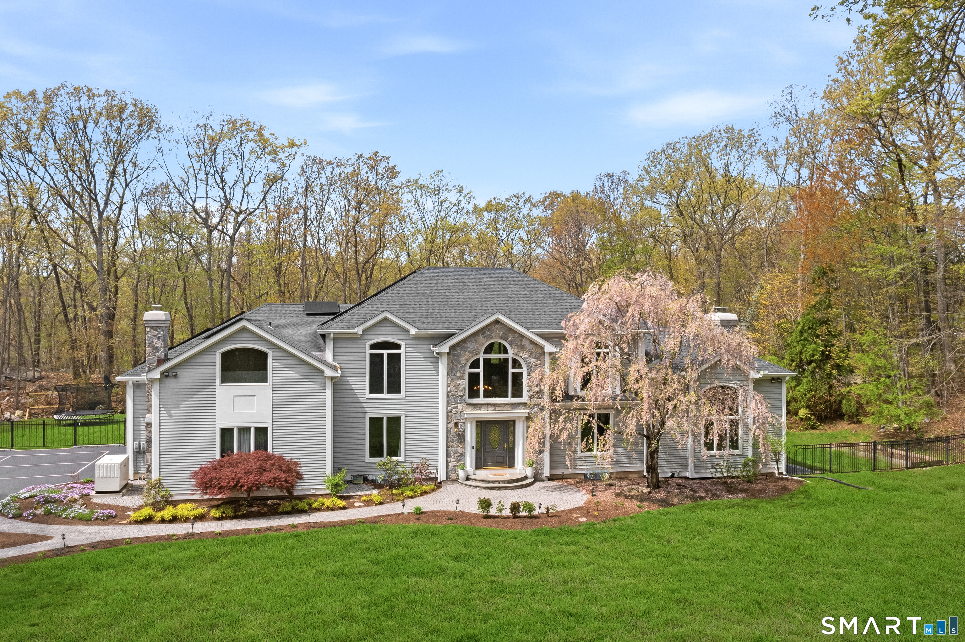 63 Coventry Lane Trumbull, CT 06611 - Photo 1 of 30 a front view of a house with a garden and trees
