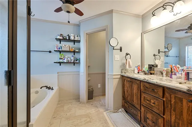 a spacious bathroom with a double vanity sink a mirror and shower