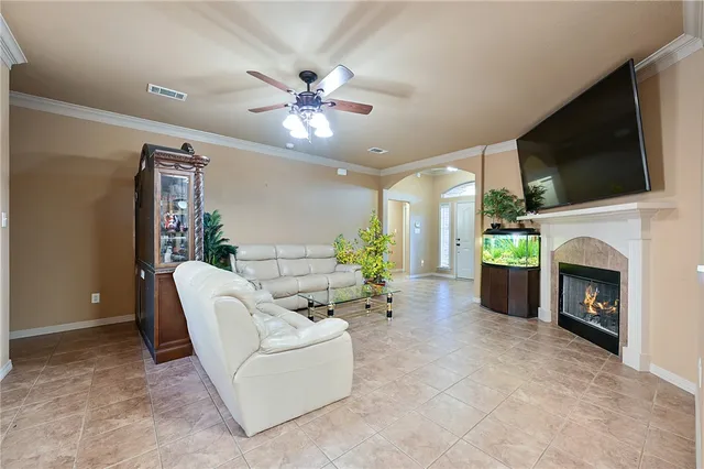a living room with furniture a flat screen tv and a fireplace