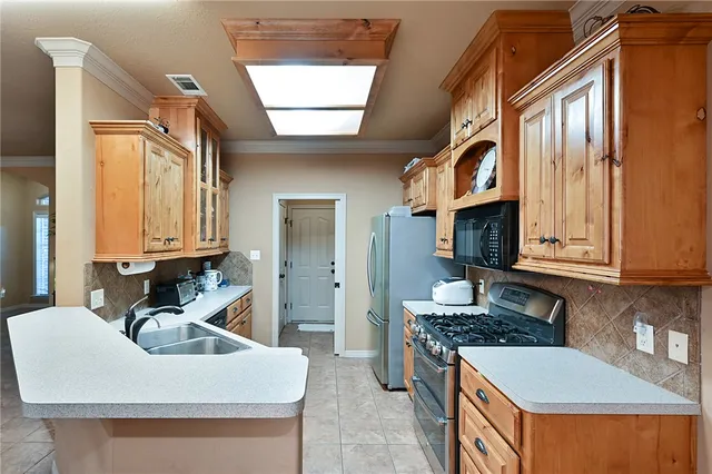 a kitchen with a stove a sink and a refrigerator