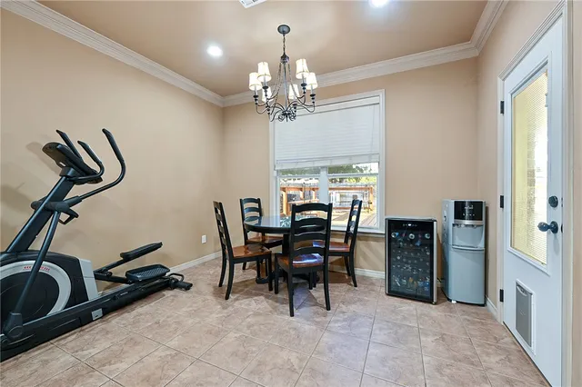 a view of a dining room with furniture and chandelier