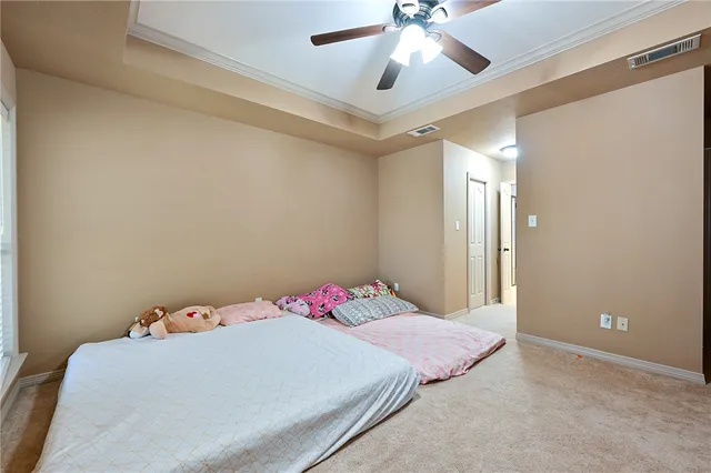 a bedroom with a bed and a chandelier