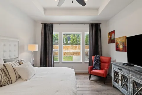 a bedroom with a bed and a television