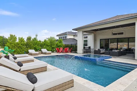 a view of an house with backyard porch and furniture