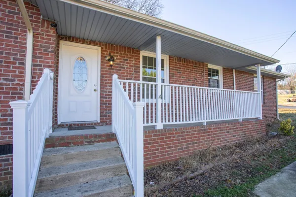 a view of a house with backyard and wooden fence
