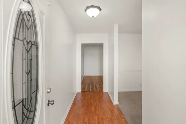 a view of hallway with wooden floor