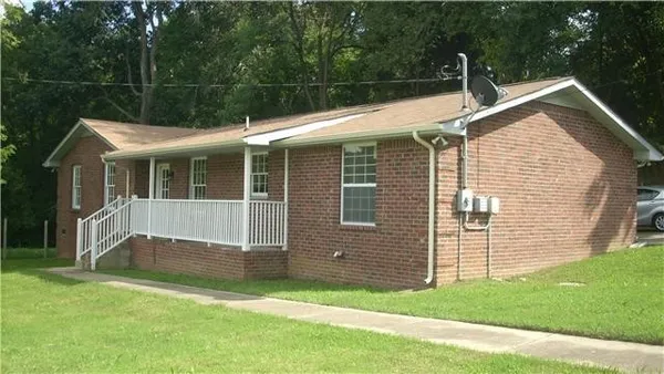 a view of house with backyard
