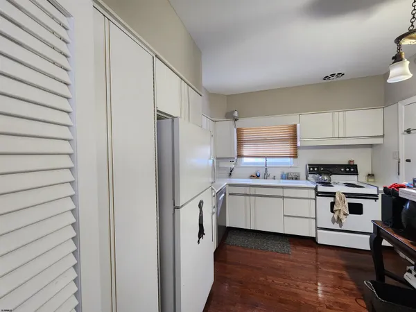 a kitchen with a refrigerator and a stove