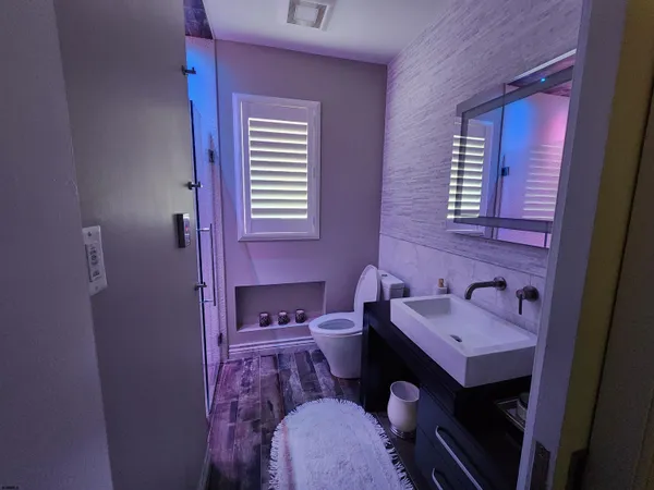 a bathroom with a sink a toilet and a mirror