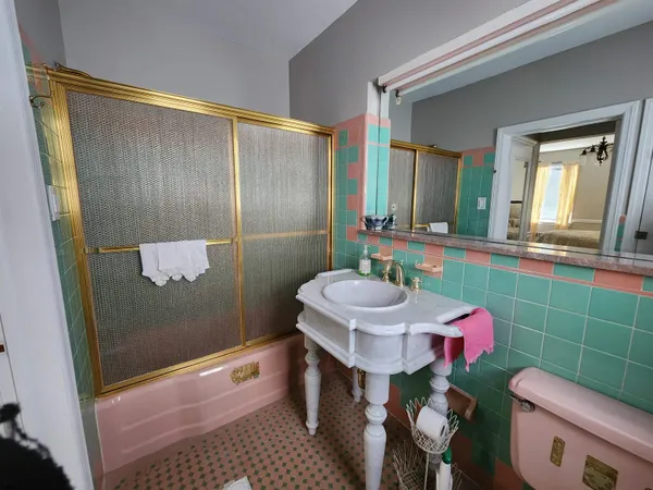 a bathroom with a sink a toilet and shower