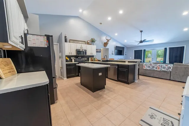 a kitchen with appliances and a refrigerator