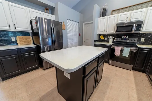 a kitchen with a sink stove and refrigerator