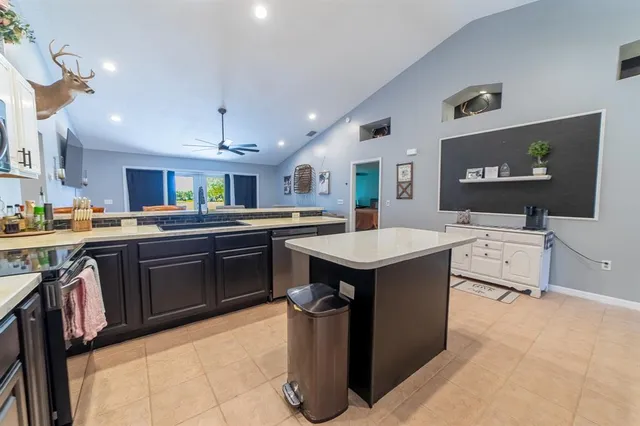 a kitchen with stainless steel appliances granite countertop a stove and a microwave