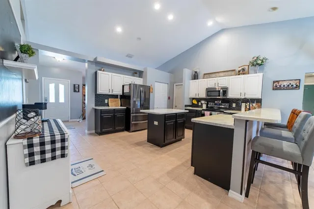 a kitchen with granite countertop a sink and a stove